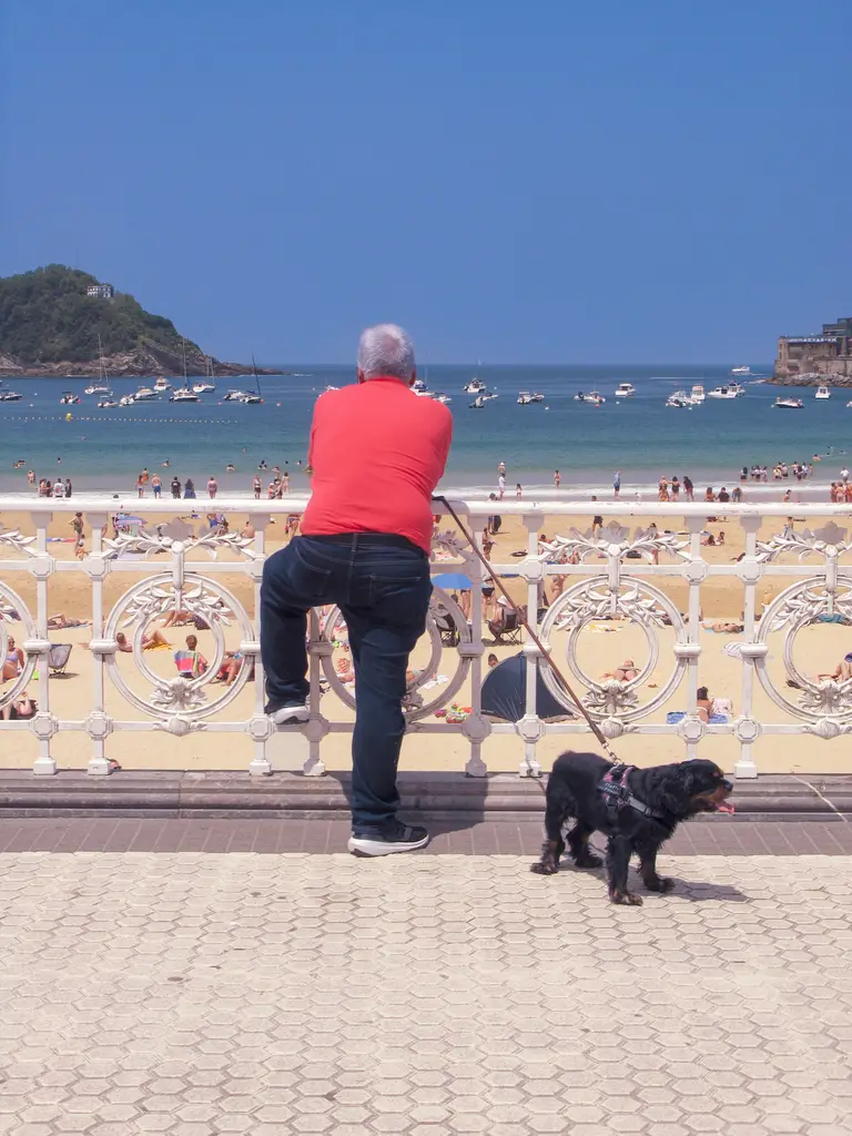 man with his dog on La Concha